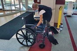 Ambassador preparing a patient wheelchair
